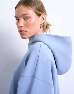 Model wearing Premium scuba oversized jean grazer hoodie in blue