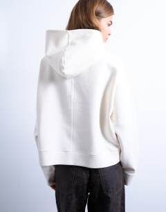 Model wearing Premium scuba-style fabric oversized jean grazer hoodie in ecru