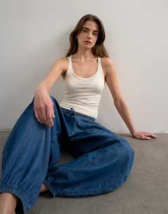 Model wearing Premium semi sheer spaghetti strap scoop racer vest in ecru