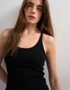 Model wearing Premium spaghetti strap scoop racer vest in black