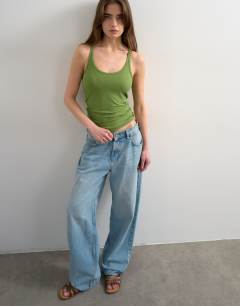 Model wearing Premium spaghetti strap scoop racer vest in green