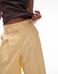 Model wearing Premium tailored wide leg cupro trousers in buttermilk