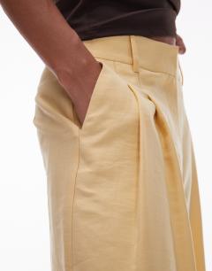 Model wearing Premium tailored wide leg cupro trousers in buttermilk