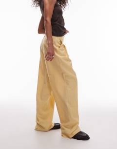 Model wearing Premium tailored wide leg cupro trousers in buttermilk