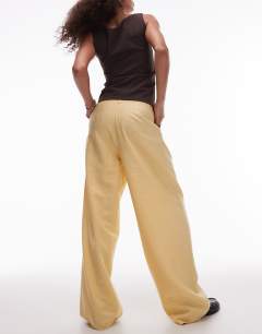 Model wearing Premium tailored wide leg cupro trousers in buttermilk