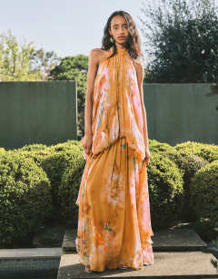Model wearing Premium viscose blouson halter neck maxi dress with open back and train in handpainted floral print
