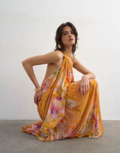 Model wearing Premium viscose blouson halter neck maxi dress with open back and train in handpainted floral print