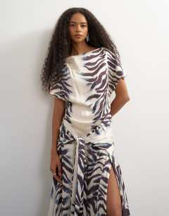 Model wearing Premium viscose satin dropped tie waist maxi dress in mono zebra