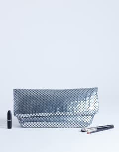 Model wearing Prince Chainmail oversized clutch bag in silver