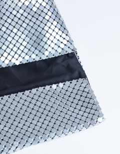 Model wearing Prince Chainmail oversized clutch bag in silver