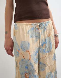 Model wearing Printed floral jaquard satin wide leg trouser in multi