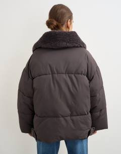 Model wearing Puffer with detachable borg collar in chocolate