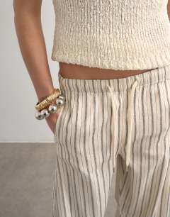 Model wearing Pull on barrel jean in ecru stripe