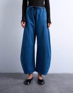 Model wearing Pull on barrel jean in mid blue