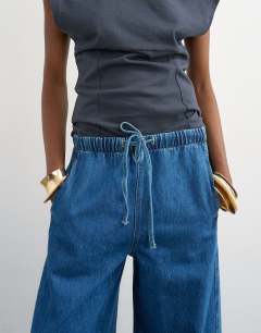 Model wearing Pull on barrel jean in rich blue