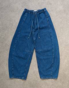 Model wearing Pull on barrel jean in rich blue