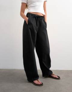 Model wearing Pull on barrel jean in washed black