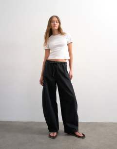 Model wearing Pull on barrel jean in washed black