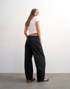 Model wearing Pull on barrel jean in washed black