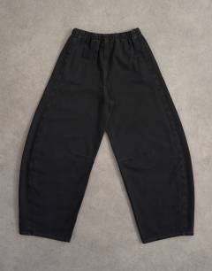 Model wearing Pull on barrel jean in washed black