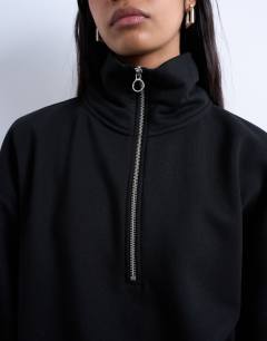 Model wearing Quarter zip sweat in black