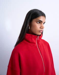 Model wearing Quarter zip sweat in red