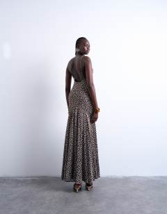 Model wearing Racer neck drop waist maxi dress in chocolate brown polka dot