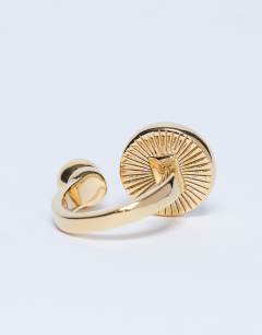 Model wearing Rae stainless steel ring with tiger eye stone in gold