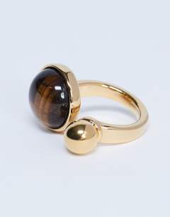 Model wearing Rae stainless steel ring with tiger eye stone in gold