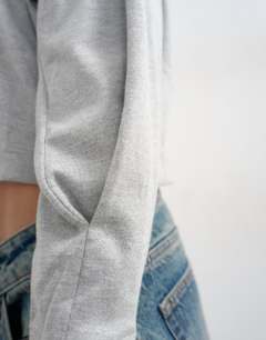 Model wearing Raglan cinch cuff long sleeve top in grey marl