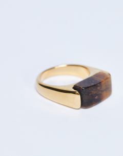 Model wearing Raquel stainless steel tiger stone ring in gold