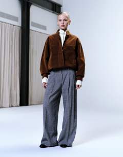 Raw hem low slung double pleated tailored trouser in dark charcoal