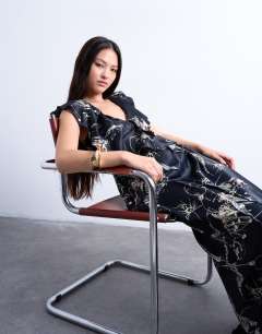 Model wearing Raw seemed frill maxi dress in mono winding floral