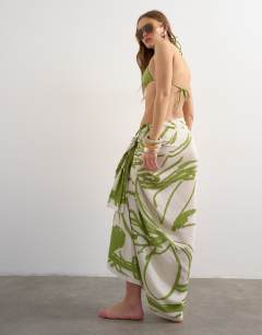 Model wearing Rectangle sarong in off white and green abstract print