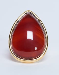 Model wearing Remi waterproof stainless steel ring with semi precious stone in gold and burnt orange