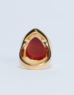 Model wearing Remi waterproof stainless steel ring with semi precious stone in gold and burnt orange