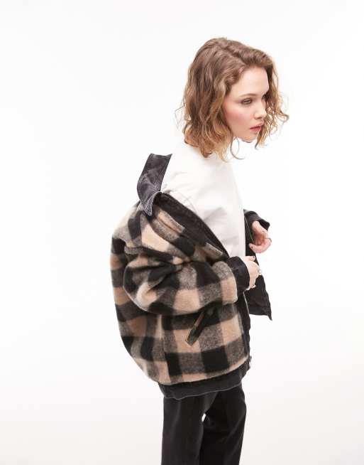 Topshop reversible check oversized denim jacket in washed black. This jacket has a Reversible design with a check beige and black design on one side and washed black denim on the other. This jacket has a Spread collar, Zip fastening and Functional pockets.
Oversized fit