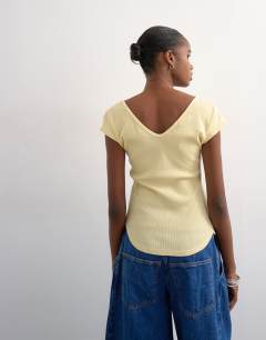 Model wearing Rib v-neck cap sleeve tank in buttermilk