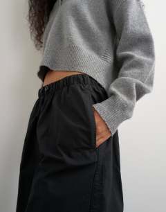 Model wearing Ripstop short with toggle detail in black
