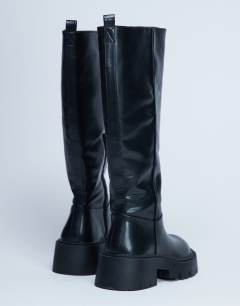 Model wearing Riya knee high chunky boots in black
