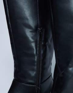 Model wearing Riya knee high chunky boots in black