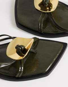 Model wearing Rolo hardware detail flat sandal in olive