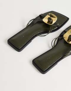 Model wearing Rolo hardware detail flat sandal in olive