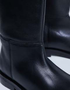 Model wearing Rory real leather riding boots in black