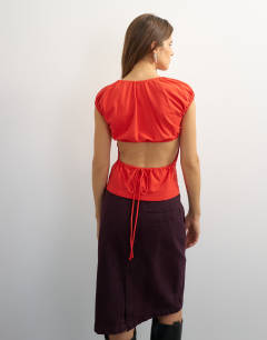 Model wearing Ruched back cut out top in red