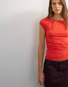 Model wearing Ruched back cut out top in red