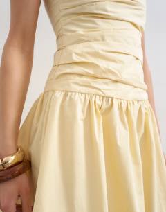 Model wearing Ruched bandeau mini dress in buttermilk