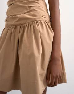 Model wearing Ruched bandeau mini dress in taupe