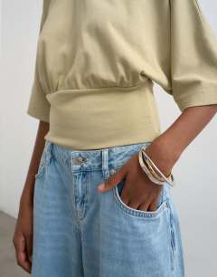 Model wearing Ruched cinch waist long sleeve top in light khaki