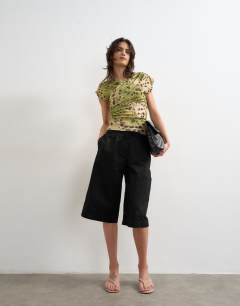 Model wearing Ruched detail wrap front short sleeve top in deer print